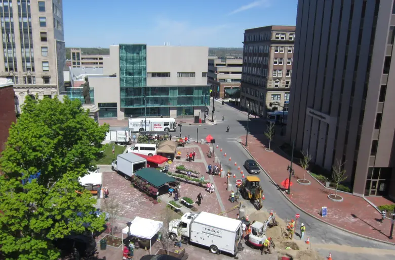 Market stalls and shoppers at the farmers' market in Monument Square, Portland, Maine, seen from above